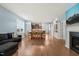 Open-concept space with hardwood floors, kitchen views, fireplace, and modern TV at 303 Bella Sq, Smithfield, NC 27577