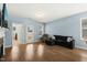 Cozy living room with hardwood floors, plush seating, and a view to a backyard at 303 Bella Sq, Smithfield, NC 27577