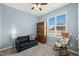 Comfortable sitting room with a ceiling fan, rocking chair, and plenty of natural light, creating a relaxing space at 303 Bella Sq, Smithfield, NC 27577