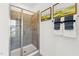 Bathroom with a glass enclosed shower with light gray tile and matching towel set on the wall at 3106 Kempthorne Rd # 57, Cary, NC 27519