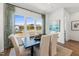 Bright dining room with a dark wood table, white upholstered chairs, and a large window with scenic views at 2900 Kempthorne Rd # 57, Cary, NC 27519