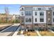 Stately townhome featuring brick accents and neutral siding, set amidst landscaped grounds on a sunny day at 2900 Kempthorne Rd # 57, Cary, NC 27519