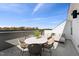 Outdoor patio featuring a lounge set, table, and seating with distant treetop views and sunny skies at 2900 Kempthorne Rd # 57, Cary, NC 27519
