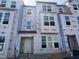 New construction townhome showcasing multiple windows and an entrance door at 319 Chesapeake Commons St # 103, Garner, NC 27529