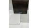 Material selection showcasing dark cabinet, countertop, and flooring options for a modern interior design at 319 Chesapeake Commons St # 103, Garner, NC 27529