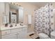 Full bathroom featuring a single sink vanity and a shower with a decorative curtain at 3322 Wellington Ridge Loop, Cary, NC 27518