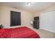 Relaxing bedroom with neutral walls, a plush red bed, and a minimalist black dresser at 3322 Wellington Ridge Loop, Cary, NC 27518
