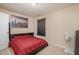 Inviting bedroom with neutral tones, carpet, and a bed featuring red bedding, creating a warm, comfortable space at 3322 Wellington Ridge Loop, Cary, NC 27518