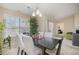 Well-lit dining room features a modern table, bright windows, and comfortable seating for entertaining at 3322 Wellington Ridge Loop, Cary, NC 27518