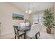 Elegant dining room with modern lighting, a large window, and seating for four at 3322 Wellington Ridge Loop, Cary, NC 27518