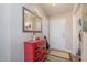 Inviting entryway with a red accent cabinet, a large mirror, and a neutral color scheme at 3322 Wellington Ridge Loop, Cary, NC 27518