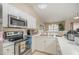 Bright kitchen features white cabinetry, stainless steel appliances, and ample counter space at 3322 Wellington Ridge Loop, Cary, NC 27518