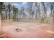 Outdoor tennis court surrounded by fencing and mature trees at 3322 Wellington Ridge Loop, Cary, NC 27518