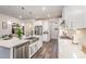 Spacious kitchen featuring a large island with a farmhouse sink, stainless steel appliances and modern finishes at 3516 Cider Cv, Apex, NC 27502