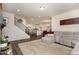 Open-concept living room showcasing the staircase and a view into the bright, modern kitchen at 3516 Cider Cv, Apex, NC 27502