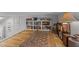 Finished attic space with hardwood floors, book shelves, rug and access to stairway at 381 Reams Dr, Middlesex, NC 27557
