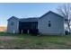 Backyard view of the home featuring siding, covered porch, and grill at 381 Reams Dr, Middlesex, NC 27557