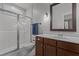 Bathroom with a glass-enclosed shower, modern vanity, wood cabinets and fixtures at 381 Reams Dr, Middlesex, NC 27557