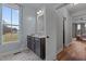 Bathroom featuring vanity and mirror, a window with curtains, and access to closet and bedroom at 381 Reams Dr, Middlesex, NC 27557