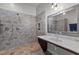 Bathroom showcasing tiled shower with multiple heads, stylish vanity with mirror and sconce lighting at 381 Reams Dr, Middlesex, NC 27557