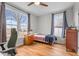 Sunlit bedroom featuring hardwood floors, a single bed, and two windows offering pleasant outdoor views at 381 Reams Dr, Middlesex, NC 27557