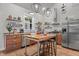 A cozy kitchen with wood countertops, stainless steel appliances, open shelving, and modern lighting at 381 Reams Dr, Middlesex, NC 27557