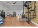Open living space features wood floors, wood-burning stove, spiral staircase, and dining area with hutch at 381 Reams Dr, Middlesex, NC 27557