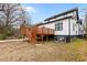 A wooden deck with steps overlooks the backyard in a cozy landscaped yard at 405 N Hyde Park Ave, Durham, NC 27703