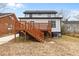 The backyard offers a wooden deck with steps in a cozy landscaped yard at 405 N Hyde Park Ave, Durham, NC 27703
