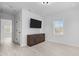 Bright bedroom featuring a wall-mounted TV and dark wood cabinet at 405 N Hyde Park Ave, Durham, NC 27703