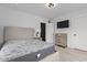 Bedroom with a wood dresser, modern light fixture, and brick accent wall at 405 N Hyde Park Ave, Durham, NC 27703