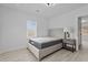 Bright bedroom with a neutral bed frame, side table, and natural light at 405 N Hyde Park Ave, Durham, NC 27703