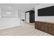 Inviting bonus room with an accent wall and a dark wooden media cabinet, perfect for relaxation and entertainment at 405 N Hyde Park Ave, Durham, NC 27703