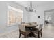Inviting dining area with a modern light fixture and a view of the bright living space at 405 N Hyde Park Ave, Durham, NC 27703