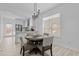 Cozy dining area with a round table, chandelier, and an open view to the kitchen at 405 N Hyde Park Ave, Durham, NC 27703