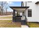 Close-up of the home's front porch featuring black brick pillars and sleek, modern railing at 405 N Hyde Park Ave, Durham, NC 27703