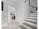 Bright hallway leading into a beautifully renovated kitchen and dining area, with access to the staircase at 405 N Hyde Park Ave, Durham, NC 27703