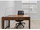Bright office space featuring a modern desk, ergonomic chair, and ample natural light from a large window at 405 N Hyde Park Ave, Durham, NC 27703