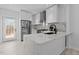 Bright, modern kitchen featuring white cabinets, stainless steel appliances, and sleek countertops at 405 N Hyde Park Ave, Durham, NC 27703