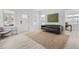 Open-concept living room with modern finishes, sleek furniture, and abundant natural light at 405 N Hyde Park Ave, Durham, NC 27703