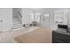 Bright living room with white walls, light wood floors, and a staircase, offering a fresh, modern feel at 405 N Hyde Park Ave, Durham, NC 27703