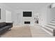 Modern living room with a marble fireplace, sleek furniture, and an open layout for versatile living at 405 N Hyde Park Ave, Durham, NC 27703