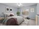 Cozy bedroom featuring a ceiling fan, area rug, and a window view at 414 Travertine Dr, Cary, NC 27519