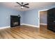 Living room with laminate flooring, light blue walls, a fireplace, and a black door at 416 E Fremont St, Kenly, NC 27542