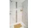 Elegant stand-up shower features neutral tile and a bamboo mat at 416 E Fremont St, Kenly, NC 27542