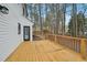Back deck and spacious yard with a wood fence and treed perimeter at 4436 Talcott Dr, Durham, NC 27705