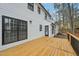 The house has a back deck with wood railings and steps down to a brick patio at 4436 Talcott Dr, Durham, NC 27705
