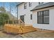 A wooden back deck has dark metal railings and steps down to a brick patio at 4436 Talcott Dr, Durham, NC 27705