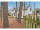 Large white house with a backyard deck, as seen through the surrounding trees at 4436 Talcott Dr, Durham, NC 27705