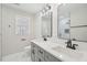 Bright bathroom featuring double vanity with sleek fixtures and a modern, glass-enclosed shower at 4436 Talcott Dr, Durham, NC 27705